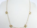 gold plated necklace with bird charms on a mannequin neck