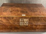 a large wooden box with a decorative design on the lid