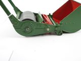 a small green machine that is on a white surface