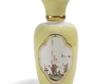 un vase jaune orné d'un motif sur fond blanc