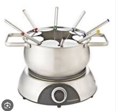 a fondgril pot with a bunch of forks in it