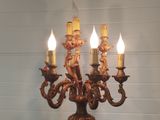 five candles that are lit up on a candle holder
