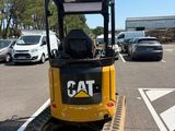a cat excavator that is parked in a parking lot
