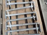 a pile of screws and bolts on a pallet next to a pair of shoes