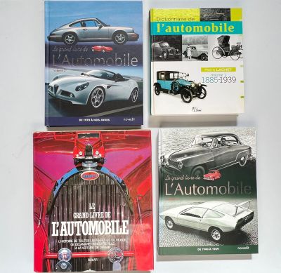 four books of automobile and automobile books on a white surface