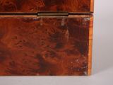 a small wooden box with a lid on a table