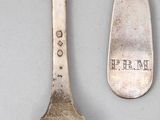 a fork and a spoon sitting next to each other on a table