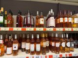 many bottles of wine on the shelves in the store