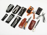 many different types of knives and sheaths laid out on a white surface