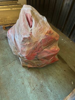 a bag of meat sitting on the floor next to a door