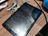 a tablet computer sitting on a desk next to a phone