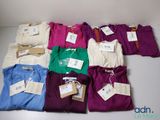 a lot of shirts that are sitting on a table