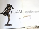 an open book with a statue of a woman on it