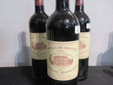 trois bouteilles de vin posées sur une table, l'une à côté de l'autre