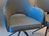 two chairs sitting next to each other on a white surface