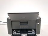 the printer is sitting on top of the tray on the table
