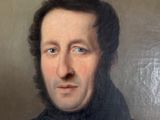 portrait of a man in a black coat with a white shirt and black tie