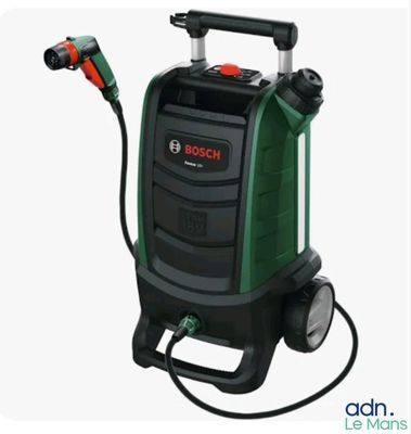 a green and black vacuum cleaner with a hose attached to it
