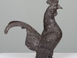 a close up of a statue of a rooster on a table