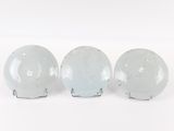 three white bowls sitting on top of each other on a white surface