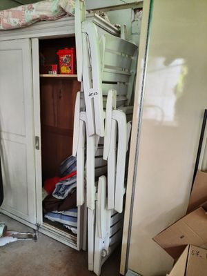 a closet full of clothes and a chair in the room