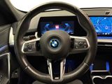the interior of a car with a steering wheel and a touch screen