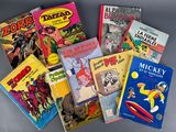 several children ' s books are lined up on a gray surface