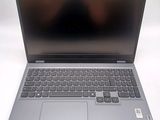 the laptop is open on a white surface with a black keyboard