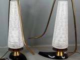 pair of brass and glass table lamps with white lampshads
