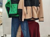 two pairs of jeans and a jacket on display in a store