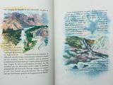 an open book with a picture of a mountain and a river in it