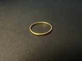 a close up of a gold ring on a black surface