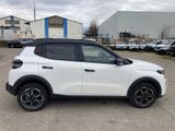 the white suv is parked in a parking lot with other cars