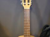 a guitar that is sitting on the floor next to a bag