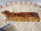 a tortoise shaped hair comb on a woven basket