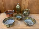 four bowls and a jug on a wooden table