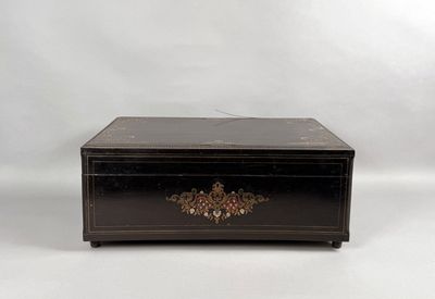 an image of a black box with a gold decoration on it