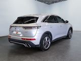 the rear end of a white suv parked in a garage