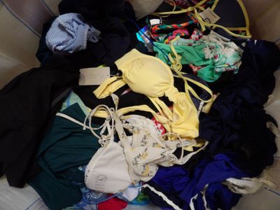 a large pile of clothes that is sitting on a couch