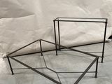 pair of iron and glass coffee tables in the shape of a hexagon