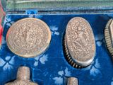 an image of a set of silver items in a blue case