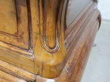 a close up of a bed with a wooden headboard