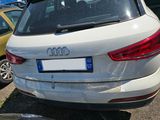a white car parked in a parking lot with other cars in the background