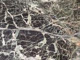 a close up of a black and green marble floor