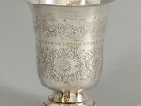 a silver cup that is sitting on top of a table