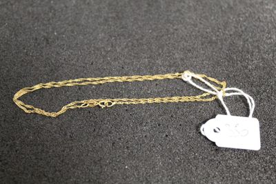 a close up of a gold chain with a tag on it