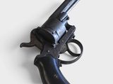 a black revolver on a white surface with a white background