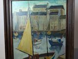 une photo d'un tableau représentant un voilier posé sur une table