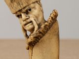 a figurine of a man with a hat on his head