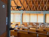 an image of a church with wooden pews and a large window